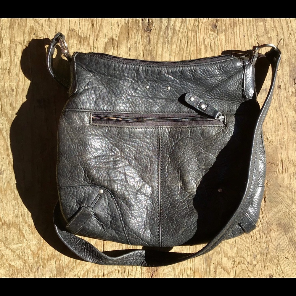 Rugged black leather shoulder bag w/rivet details